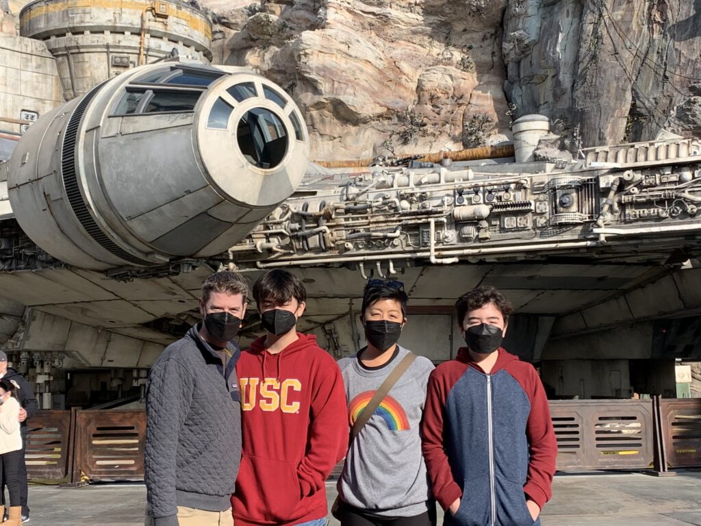 Josh and his family in front of the Millennium Falcon in Disneyland's Star Wars: Galaxy's Edge - Disneyland Through the Eyes of a Teenager - New Lands & Experiences