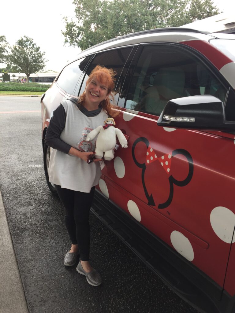 Michelle and Baymax with a Minnie Van at the Walt Disney World Resort - The 5 Songs You Should Add To Your runDisney Playlist