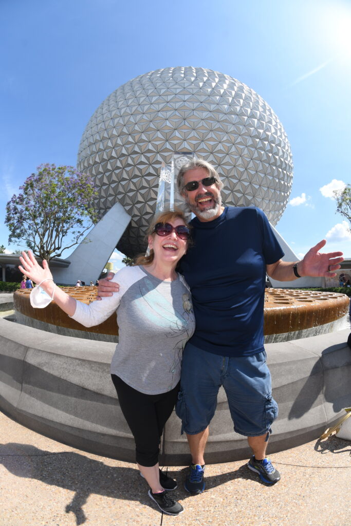 Tom and Michelle in front of Spaceship Earth at Epcot - Our May 2022 Florida Trip Recap