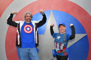 Tom and Michelle, Co-hosts of Hyperion Adventures Podcast wearing Captain America tees at Disneyland
