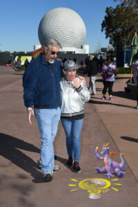 About Us - the Hyperion Adventures Podcast Co-Hosts Tom and Michelle in EPCOT with Figment