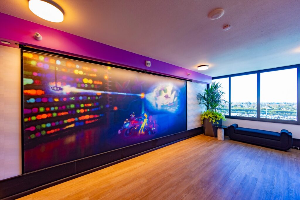 Large murals of Pixar Film scenes grace the walls on each floor by the elevators
