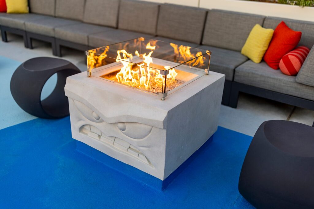 Unveiling the Magic: Pixar Place Hotel Poolside fire pit and seating area themed with Inside Out's Anger character.