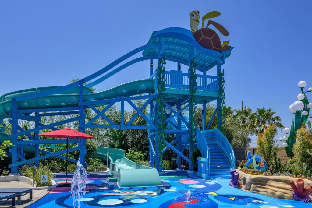 Unveiling the Magic: Pixar Place Hotel view of the Rooftop Pool slide and splash pad area.