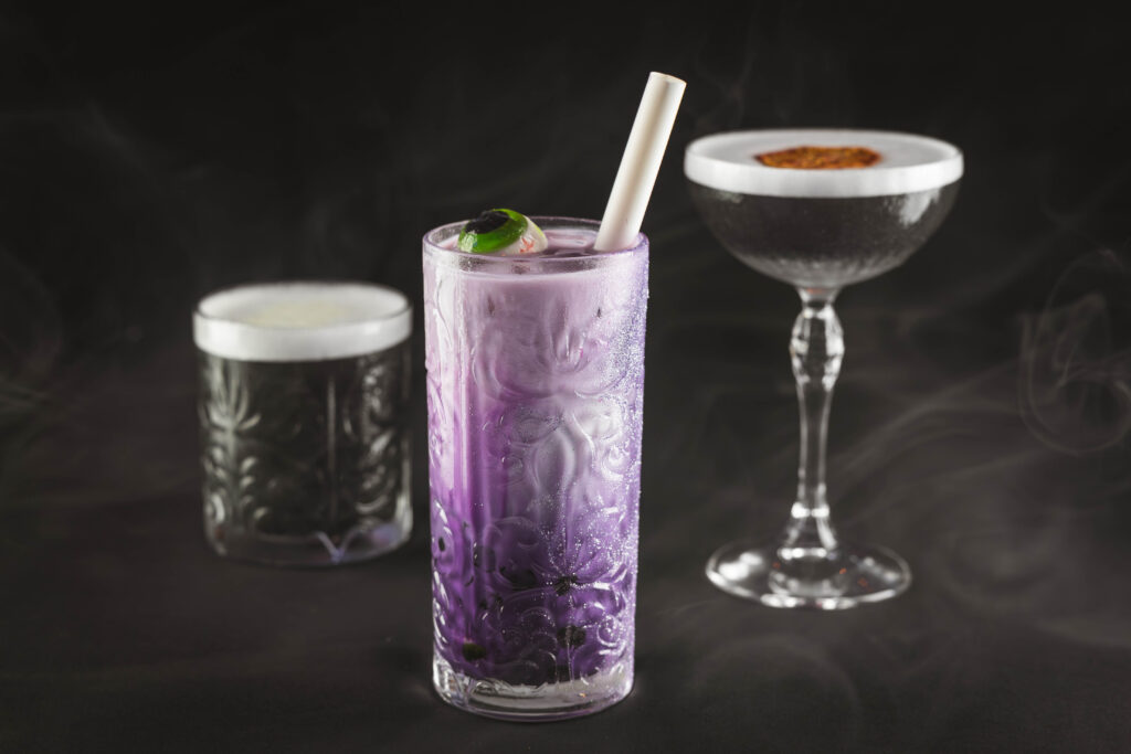A trio of drinks with an eerie look. A sampling of the signature drinks served on Disney Treasure Haunted Mansion Parlor Lounge