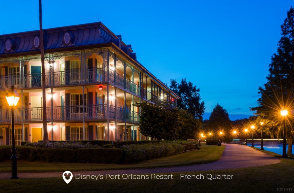 Exterior night time view of Port Orleans -French Quarter resort building with a romantic flair