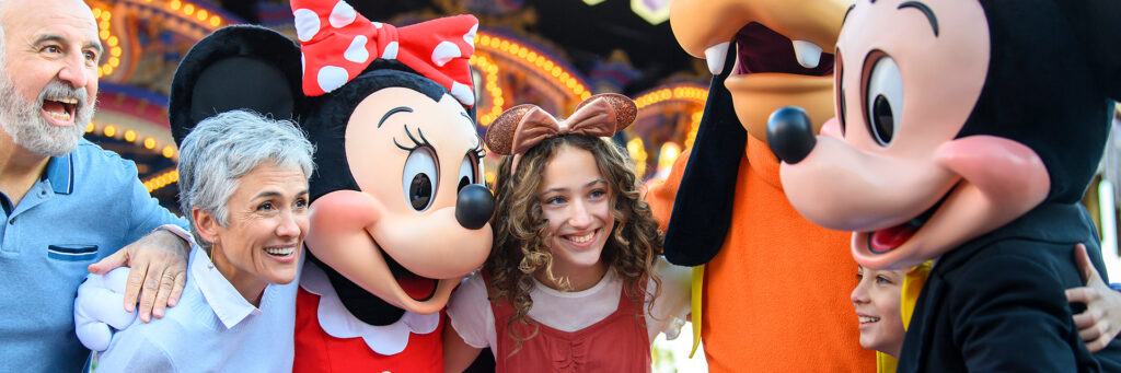 Multi-generational family with Disney Characters at the Happiest place on Earth.
