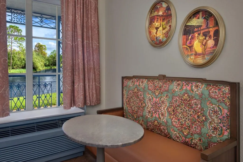 Room displaying sitting area with small table and portraits of characters from